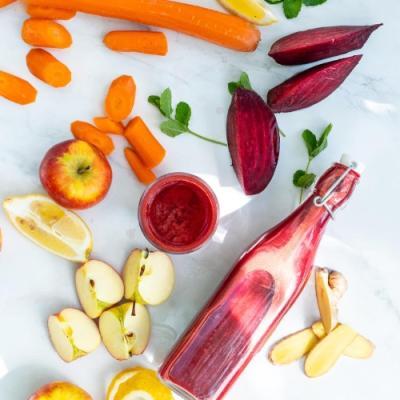 Beet juice with carrots, apple, lemon, ginger, and mint