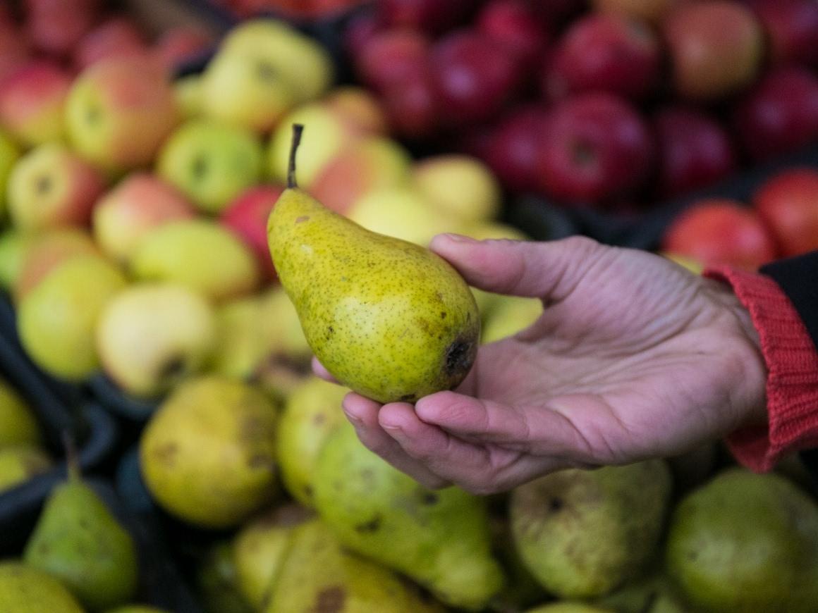 Pears and apples on a farmer's market stand.