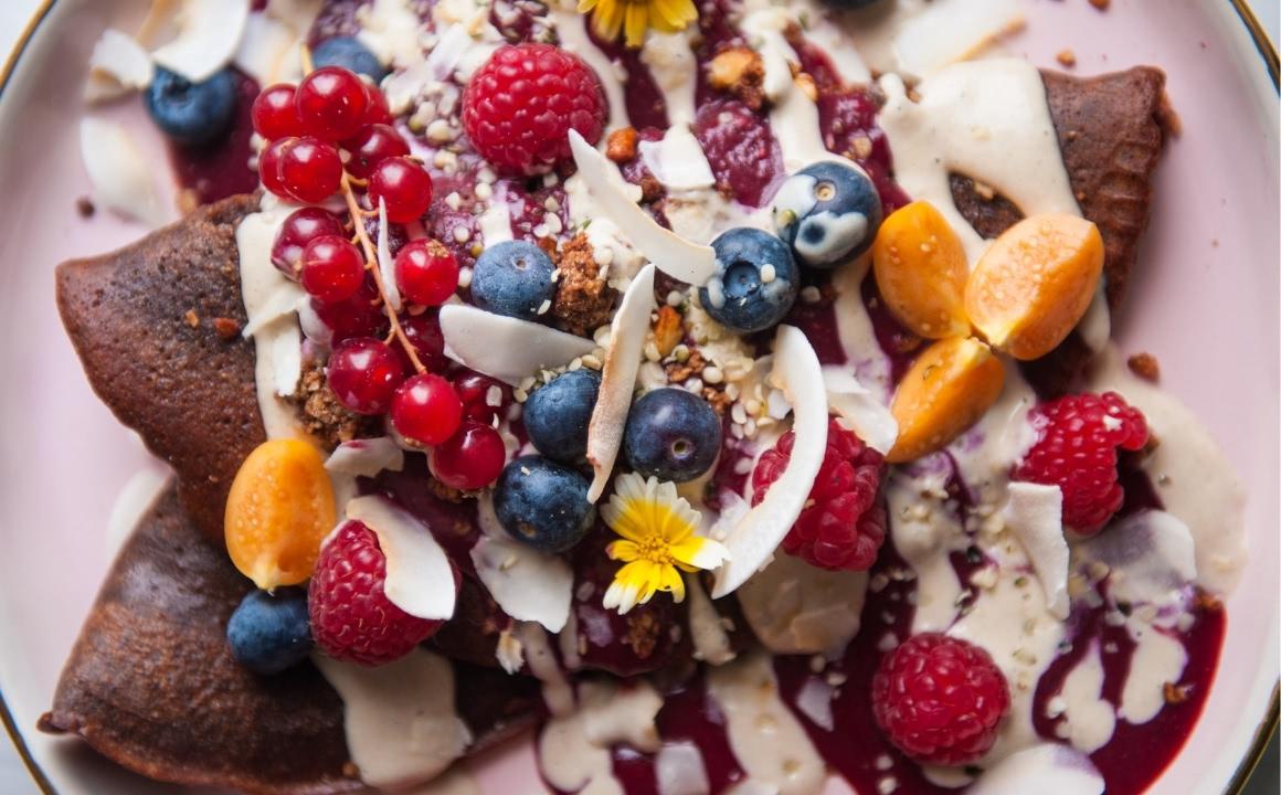 Vegan pancakes with raspberry sauce and cashew date cream