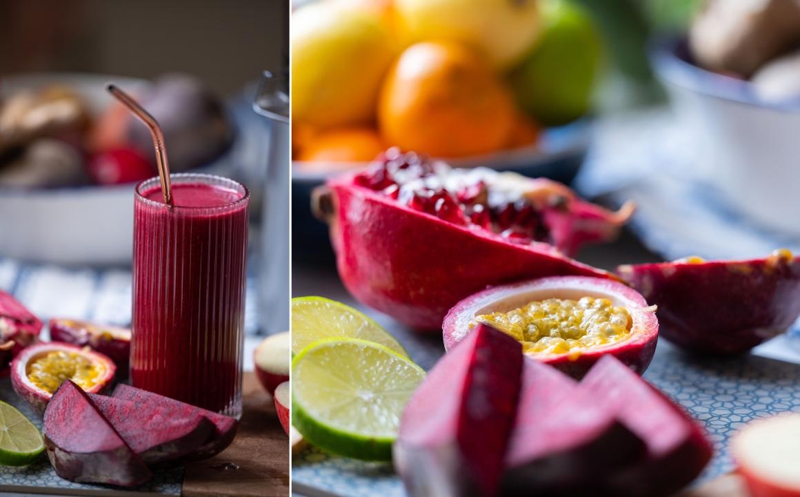 Beetroot juice in a glass with a straw - setup with beetroot, passion fruit and citrus fruits