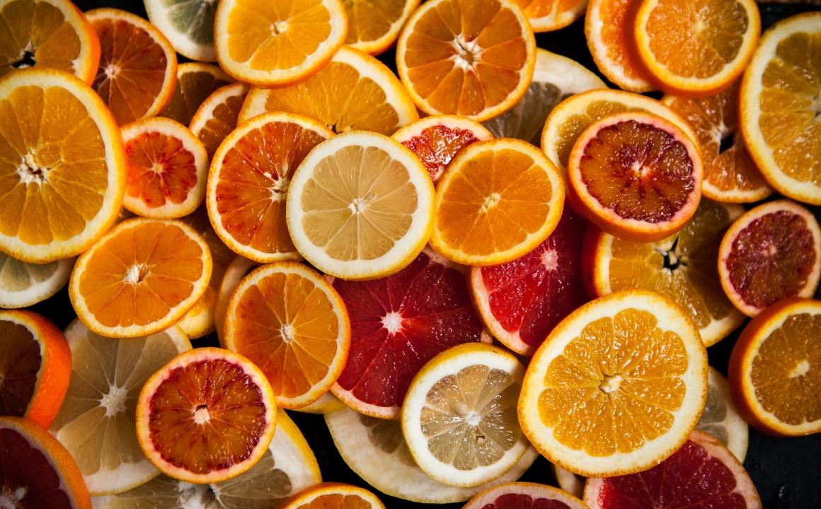 Orange slices, lemon slices on a black background
